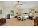Spacious bedroom featuring a ceiling fan, windows with lots of natural light, and neutral-toned carpet at 1119 Palmyra Dr, Fort Mill, SC 29708