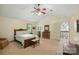 Bright bedroom with high ceilings and lots of natural light featuring a ceiling fan and a wooden bed frame at 1119 Palmyra Dr, Fort Mill, SC 29708