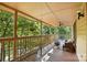 Inviting covered deck boasts wood floors, comfortable seating, and a ceiling fan, perfect for relaxing outdoors at 1119 Palmyra Dr, Fort Mill, SC 29708