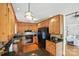 Well-lit kitchen featuring custom wood cabinetry, granite countertops, and modern black appliances at 1119 Palmyra Dr, Fort Mill, SC 29708