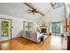 Bright living room features vaulted ceilings, wood floors, fireplace, and sliding glass doors to outdoor space at 1119 Palmyra Dr, Fort Mill, SC 29708