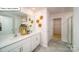 Elegant bathroom featuring double sinks, modern fixtures, and a well-lit vanity area at 119 Rustling Waters Dr, Mooresville, NC 28117