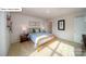 Bright bedroom with carpeted floors, side tables with lamps, and colorful skateboards on the wall at 119 Rustling Waters Dr, Mooresville, NC 28117