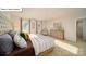 Inviting primary bedroom featuring a tufted headboard, soft lighting, and calming decor at 119 Rustling Waters Dr, Mooresville, NC 28117