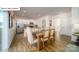 Open-concept kitchen and dining area with stainless steel appliances, a kitchen island, and hardwood floors at 119 Rustling Waters Dr, Mooresville, NC 28117