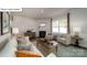 Cozy living room with neutral paint, a fireplace, comfortable seating, and natural light from the windows at 119 Rustling Waters Dr, Mooresville, NC 28117