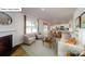 Cozy living room featuring a fireplace, large windows, and an open floor plan to the kitchen at 119 Rustling Waters Dr, Mooresville, NC 28117