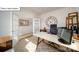 Bright home office featuring French doors, hardwood floors, a desk, and a view into the hallway at 119 Rustling Waters Dr, Mooresville, NC 28117