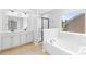 Bright bathroom featuring a double vanity, soaking tub, and separate shower at 120 Carolinian Dr, Statesville, NC 28677