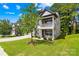 Charming two-story home with a front porch, a manicured lawn, and mature trees at 120 Carolinian Dr, Statesville, NC 28677