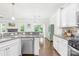 Well-lit kitchen features stainless steel appliances, granite countertops, and white cabinetry at 120 Carolinian Dr, Statesville, NC 28677