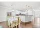 Bright and airy kitchen with modern white cabinets, a breakfast bar, and elegant dining area at 120 Carolinian Dr, Statesville, NC 28677