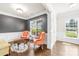 Bright living room featuring elegant wainscoting, hardwood floors, and charming furniture at 120 Carolinian Dr, Statesville, NC 28677
