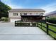 Backyard with two-story deck, black fencing, and detached garage at 1228 N Dobys Bridge Rd, Fort Mill, SC 29715