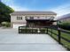 Backyard with two-story deck, black fencing, and detached garage at 1228 N Dobys Bridge Rd, Fort Mill, SC 29715