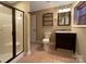 Modern bathroom featuring a glass-enclosed shower and granite sink at 1228 N Dobys Bridge Rd, Fort Mill, SC 29715