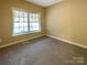 Neutral bedroom with window, carpet and neutral walls at 1228 N Dobys Bridge Rd, Fort Mill, SC 29715
