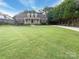 Charming brick home featuring a well-manicured lawn, covered porch, and mature trees at 1228 N Dobys Bridge Rd, Fort Mill, SC 29715