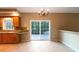 Eat-in kitchen with sliding glass doors to deck, counter seating, and stainless steel sink at 1228 N Dobys Bridge Rd, Fort Mill, SC 29715