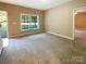 Neutral living room with carpet and a large window providing natural light near the front door at 1228 N Dobys Bridge Rd, Fort Mill, SC 29715