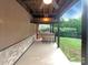 Inviting covered patio with stone bar, seating, and a ceiling fan for outdoor enjoyment at 1228 N Dobys Bridge Rd, Fort Mill, SC 29715