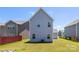 Backyard view of house with grass and blue skies at 12548 Gotland Rd # 327, Midland, NC 28107