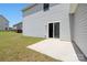 A view of the backyard with a concrete patio and sliding glass doors leading into the house at 12548 Gotland Rd # 327, Midland, NC 28107