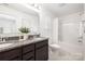 The clean bathroom features granite countertops, a double sink vanity, and a bathtub shower combo at 12548 Gotland Rd # 327, Midland, NC 28107