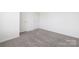 Bedroom with neutral carpet and two bright white doors at 12548 Gotland Rd # 327, Midland, NC 28107