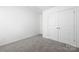 Spacious bedroom with double door closet, neutral carpet, and white walls at 12548 Gotland Rd # 327, Midland, NC 28107