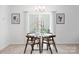 Bright dining area with modern chandelier, small glass-top table, and bright window at 12548 Gotland Rd # 327, Midland, NC 28107