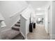 Bright entryway with wood floors, stairway, console table, and modern mirror decor at 12548 Gotland Rd # 327, Midland, NC 28107