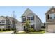 Exterior of a two-story home with light siding, attached garage, and lovely curb appeal on a sunny day at 12548 Gotland Rd # 327, Midland, NC 28107