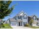 Two story home with light siding, garage, and a well manicured front lawn on a beautiful sunny day at 12548 Gotland Rd # 327, Midland, NC 28107