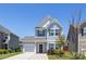 Charming two-story home features a well-manicured lawn and a classic architectural design under a clear blue sky at 12548 Gotland Rd # 327, Midland, NC 28107