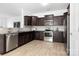 Well lit, updated kitchen with dark wood cabinets, stainless steel appliances and light wood flooring at 12548 Gotland Rd # 327, Midland, NC 28107