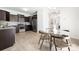 Kitchen with dark wood cabinets, stainless steel appliances, and a modern glass-topped dining table at 12548 Gotland Rd # 327, Midland, NC 28107
