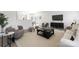 Open concept living room with a modern sofa, arm chairs, large rug, and sliding glass doors to the outside at 12548 Gotland Rd # 327, Midland, NC 28107