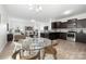 Open floor plan showing a living room and a dining area with dark brown kitchen cabinets at 12548 Gotland Rd # 327, Midland, NC 28107