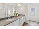 A bathroom with double sinks, gray countertops, white cabinetry, and a glass-enclosed shower at 13920 Winmau Ln, Huntersville, NC 28078