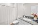 Bathroom featuring a gray countertop, white sink, a toilet, and a shower with a white curtain at 13920 Winmau Ln, Huntersville, NC 28078