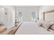 Bright bedroom with a wooden bed frame, plush bedding, and two windows allowing natural light at 13920 Winmau Ln, Huntersville, NC 28078