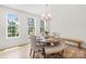 Elegant dining room featuring a round table, stylish chairs, and plenty of natural light at 13920 Winmau Ln, Huntersville, NC 28078