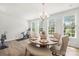 Charming dining room with ample natural light, a rustic table, and a modern Peloton bike nearby at 13920 Winmau Ln, Huntersville, NC 28078