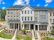 Attractive townhome featuring a brick facade, covered front porch, and manicured landscaping at 13920 Winmau Ln, Huntersville, NC 28078