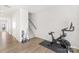 Home gym featuring a stationary bike, vacuum, and stairs, creating a space for fitness enthusiasts at 13920 Winmau Ln, Huntersville, NC 28078