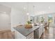 Bright kitchen featuring a large island with a sink, modern appliances, and an open dining area at 13920 Winmau Ln, Huntersville, NC 28078
