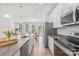 Bright kitchen with stainless steel appliances, a large island and adjoining dining space at 13920 Winmau Ln, Huntersville, NC 28078