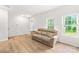 Inviting living room with wood floors, a comfortable sofa, and natural light from the windows at 13920 Winmau Ln, Huntersville, NC 28078