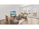 Inviting living room with ample natural light, plush seating, and a modern entertainment setup at 13920 Winmau Ln, Huntersville, NC 28078